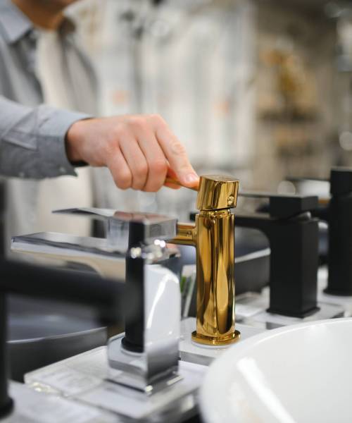 Middle age man choosing bathroom sink and utensils for his home.